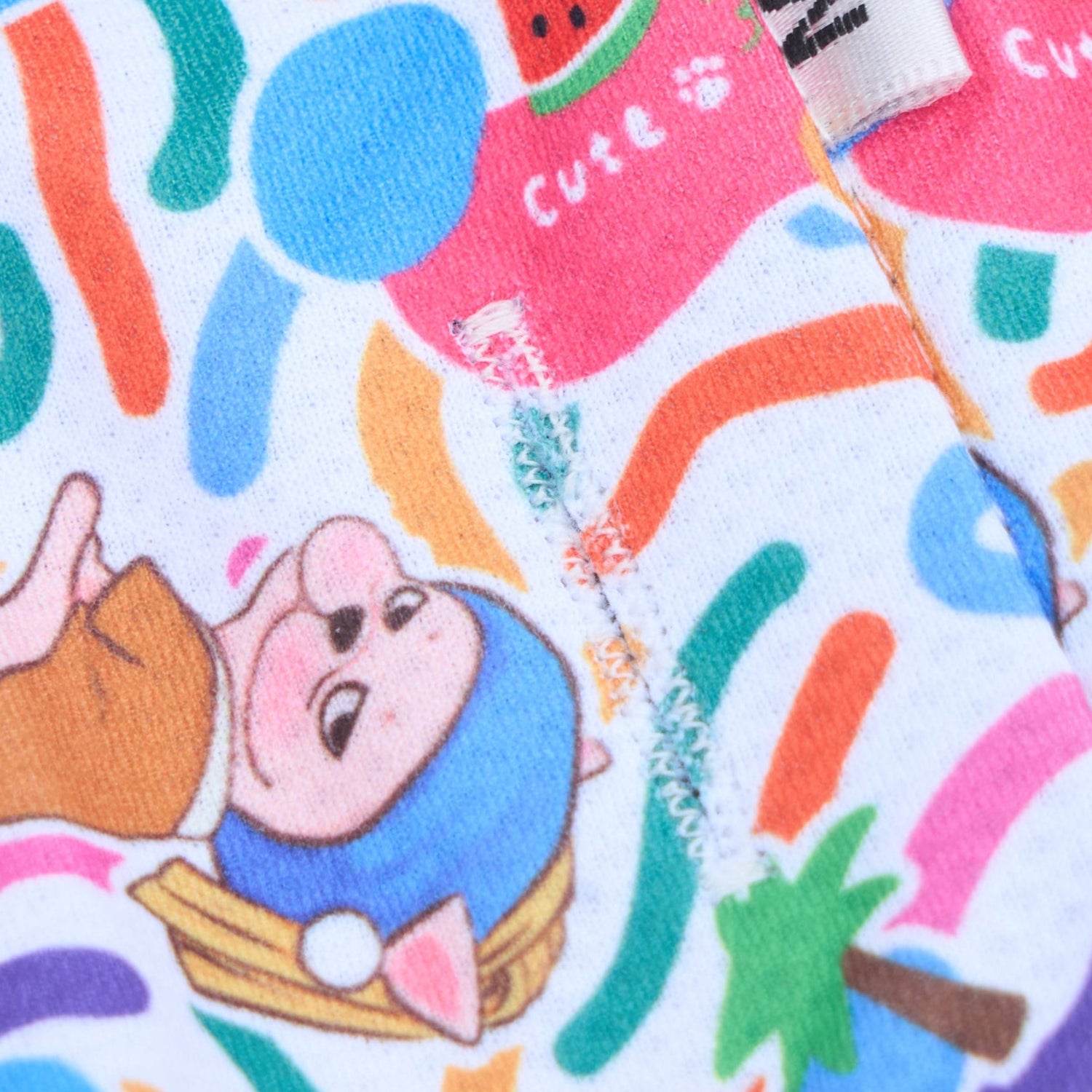 Colorful fabric with cartoon character and abstract patterns